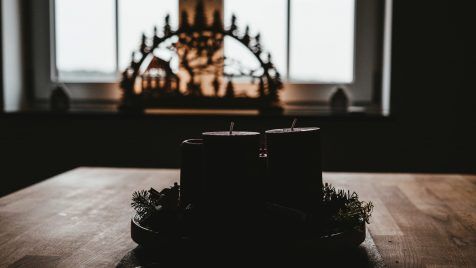 four black pillar candles on top of table