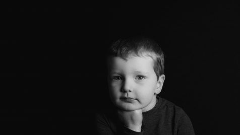 grayscale photo of boy in crew neck shirt