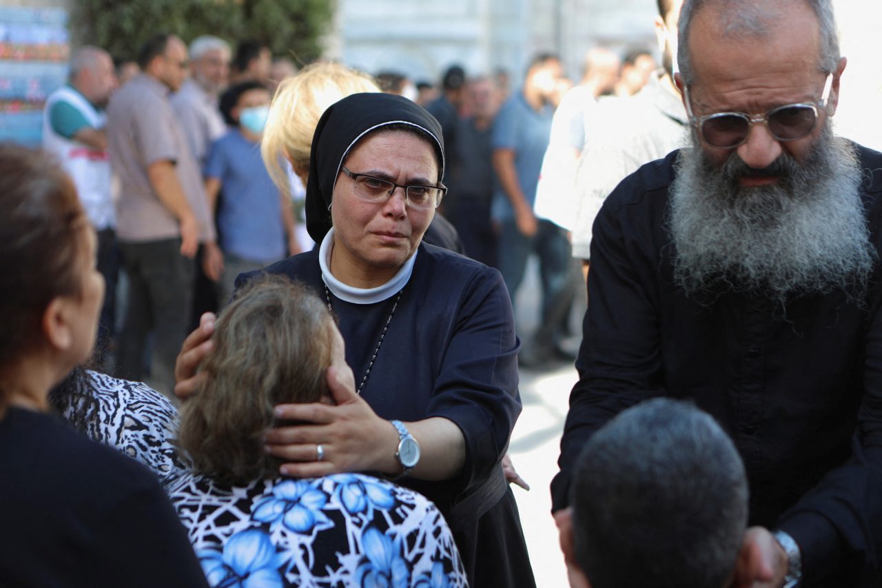 Worshippers are comforted as they attend a funeral for Palestinians killed in an Israeli strike that damaged the Greek Orthodox Saint Porphyrius Church, where Palestinians who fled their homes were taking shelter, at the church in Gaza City, October 20, 2023. REUTERS/Mohammed Al-Masri Photo: STRINGER/REUTERS
